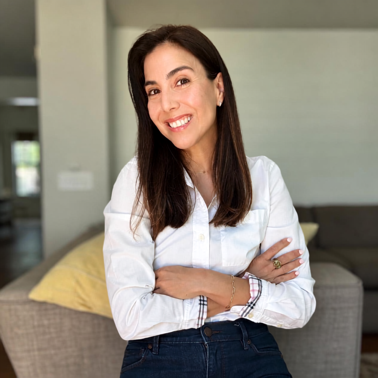 Camille standing with her arms crossed, smiling